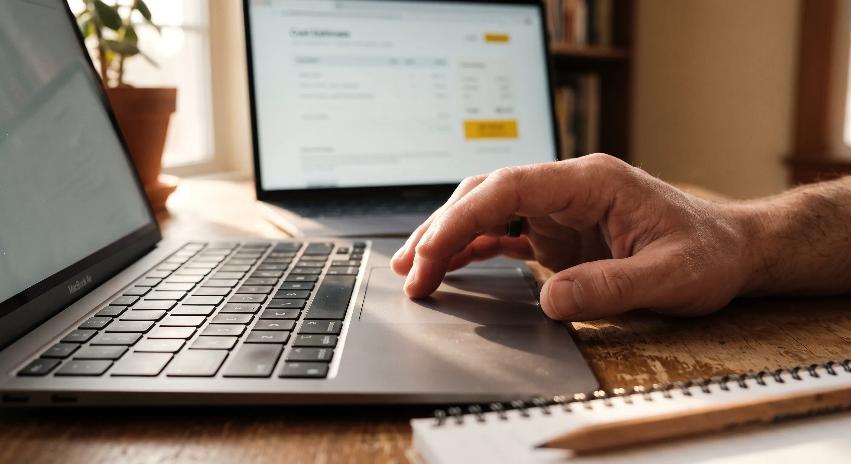 Close-up of a hand on a laptop trackpad with an estimate screen open.